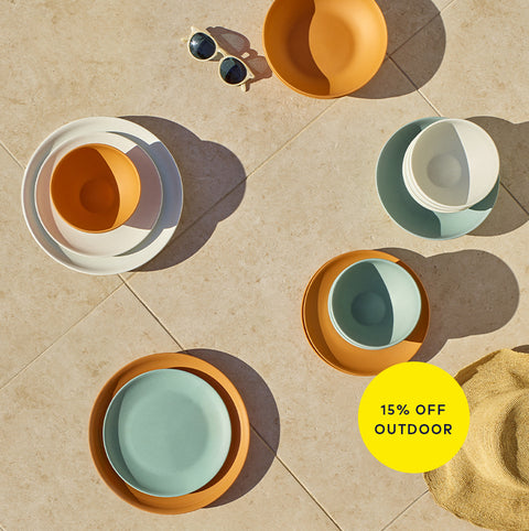 Colorful ceramic bowls on a tiled floor with a '15% Off Outdoor' label.